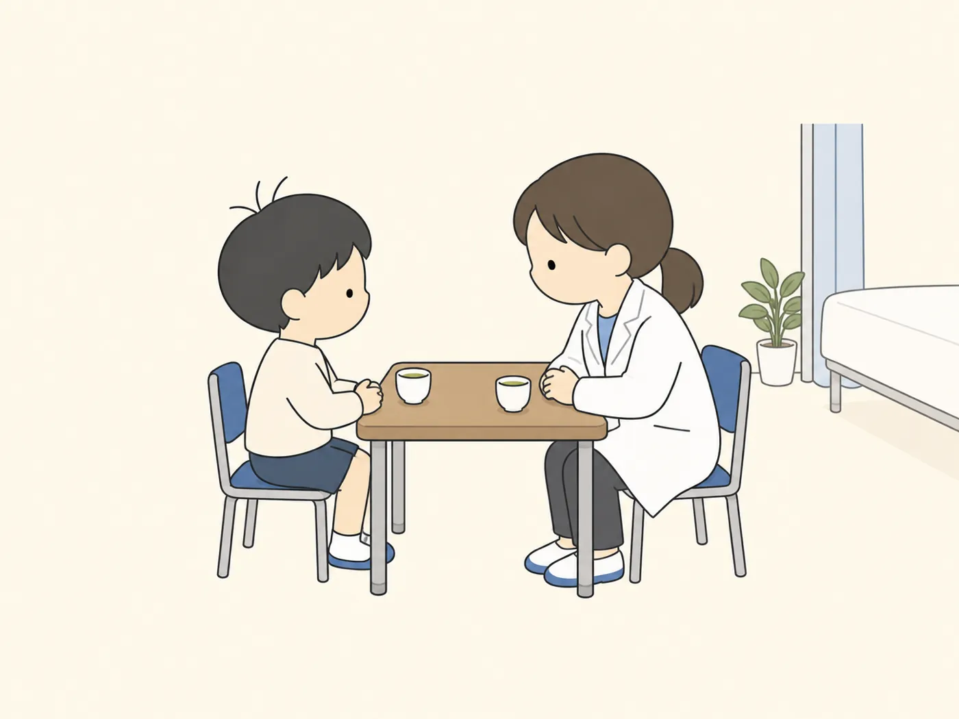 保健室で、先生と向かい合って話をする子ども